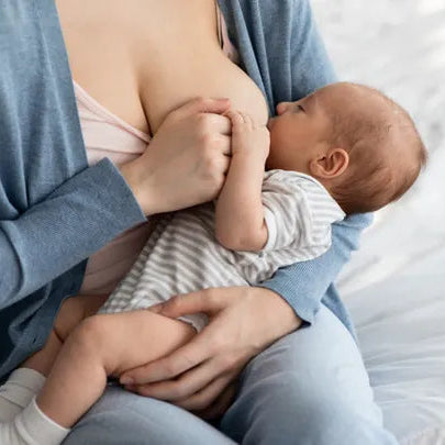 Person breastfeeding baby receiving lactation consultant support