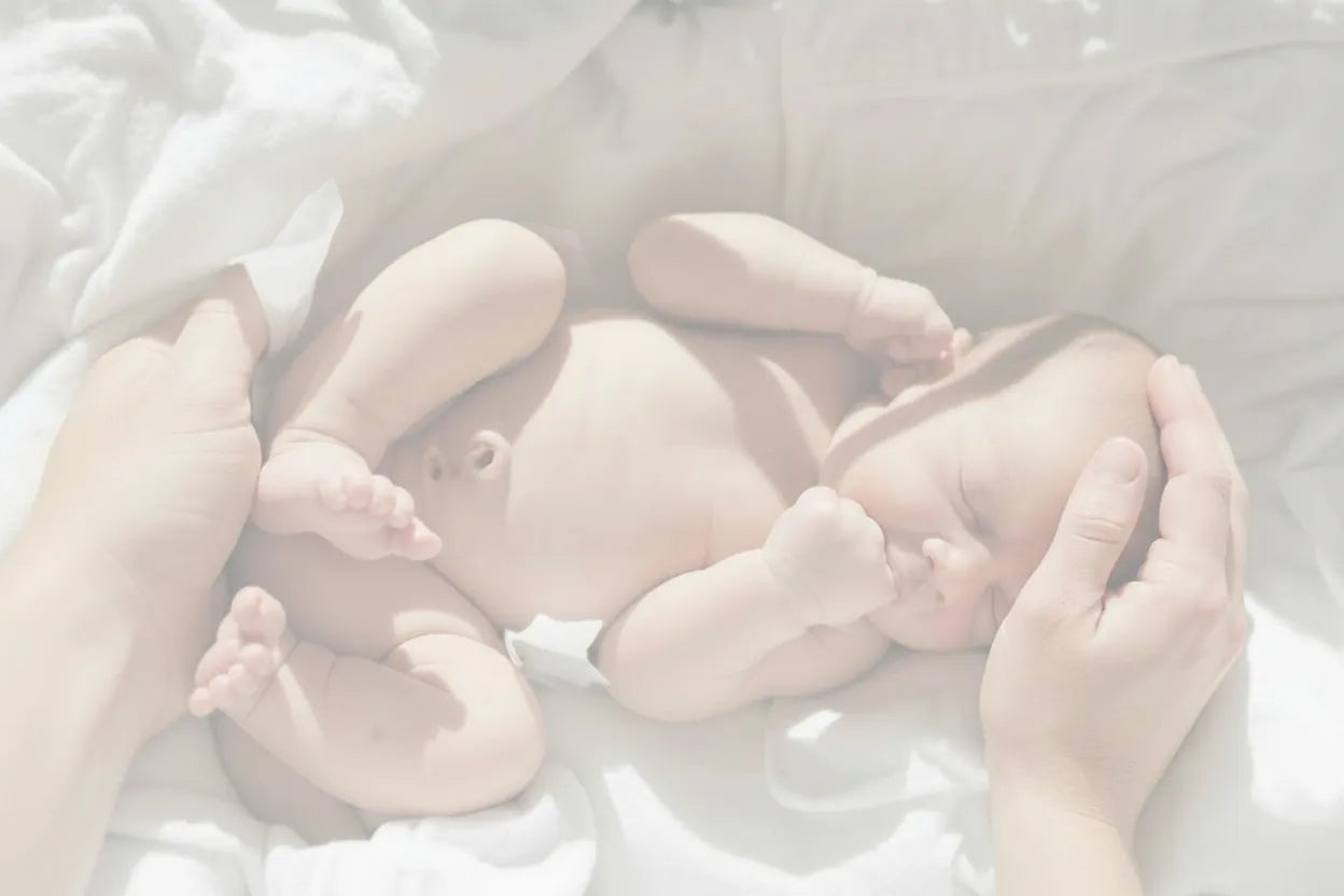 Newborn baby being comforted by adult hands. Newborn early parenting support